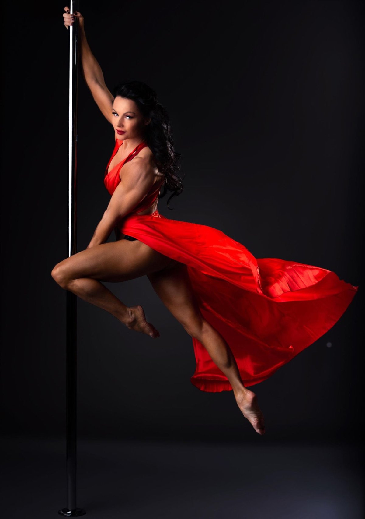 Jamilla Deville performing in a flowing red dress